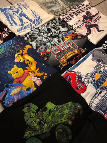 Customer's photo of assorted graphic t-shirts from a Premium Mix Bale, including designs like Greta Van Fleet and Winnie the Pooh.