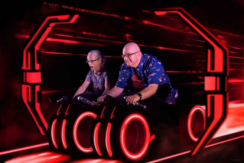 Reviewer wearing the blue Disney's Tron 'The Grid' shirt while on a futuristic lightcycle ride.