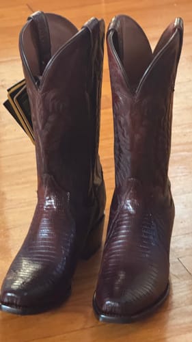 Customer's dark brown Ringold Western Boots with lizard texture, standing on a wooden floor.