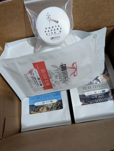 Customer's coffee order in an open box, with the Holiday Blend 2025 bag featured prominently on top.