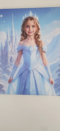 Customer's personalized "The Ice Princess" portrait of a young girl in a blue gown and ice crown in a snowy setting.