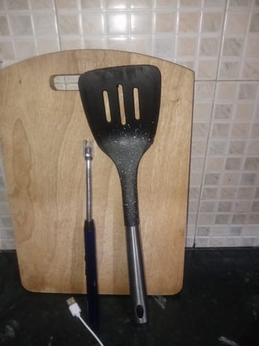 Customer's great quality kitchen utensils: a black spatula and a blue electric lighter.
