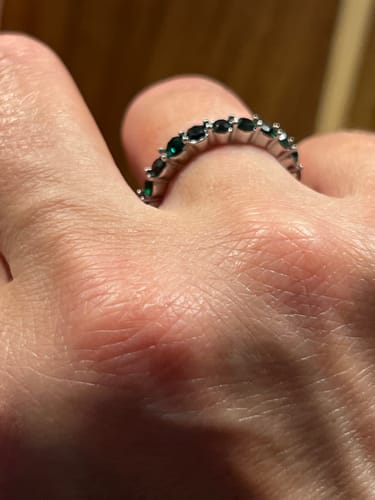 Customer's Emerald Beauty Silver Crystal Ring worn on a finger, featuring dark green stones