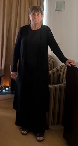 Customer's black Brigitte Brianna Essential Set including a long cardigan, tank top, and pants worn standing indoors.