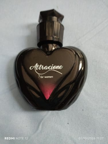 Customer's Attracione Sensual perfume, a dark heart-shaped glass bottle with a black cap.
