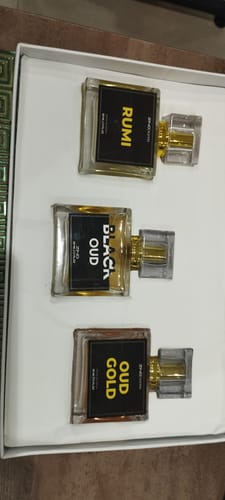 Customer's Royal Oud Collection featuring three glass perfume bottles labeled Rumi, Black Oud, and Oud Gold in a box.