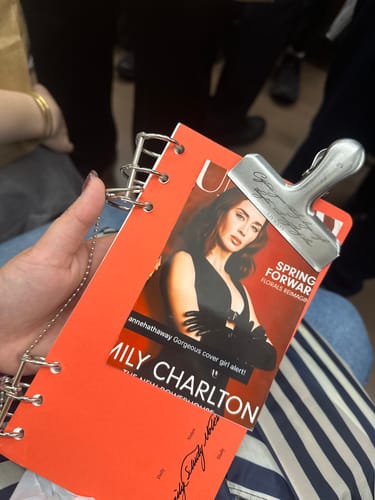 Reviewer's orange Index Notebook 3.0 held in hand, featuring a personalized cover insert and silver metal clip.