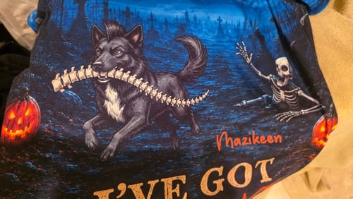 Customer's I've Got Your Back personalized shirt featuring a dark dog carrying a bone, close-up of design.