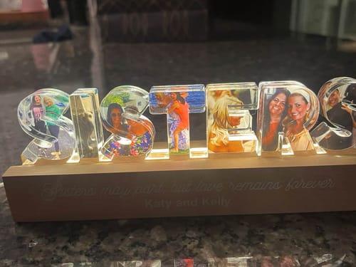 Customer's Sisters Photo Collage personalized acrylic LED night light, featuring photos on each letter on a wooden base.