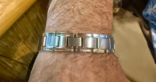 Customer's silver-tone Iron Man Titanium Magnetic Bracelet worn on their wrist.
