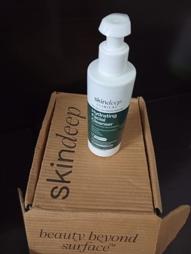 Customer's Skindeep Clinical Hydrating Facial Cleanser bottle resting on its cardboard shipping box.