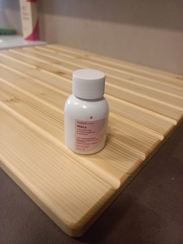 Customer's Perla laundry scent bottle resting on a wooden slatted surface