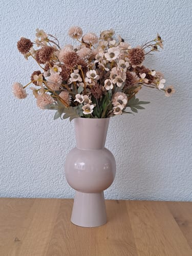 Customer's Wax Arrangement in a neutral vase, showing a lush mix of crème and brown silk flowers on a wooden table.