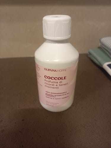 Customer's white bottle of Coccole laundry perfume sitting on a brown surface.