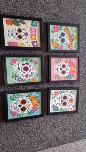 Customer's six Mini Paintings - Mexican Skull Set in black frames displayed together on a gray wall