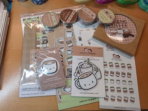 Customer's Coffee Lovers Bonus Box Set with assorted stickers, washi tape rolls, and a cute cappuccino enamel pin.