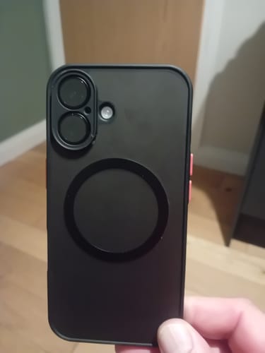 Customer's matte black iPhone MagSafe case held in hand, showing camera cutout and magnetic ring.