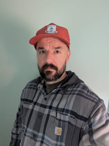 Customer's Big Relaxed Cap with custom embroidery worn by a person in a plaid shirt.