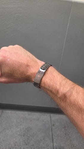 Customer's copper Lord’s Prayer magnetic bracelet worn on their wrist.