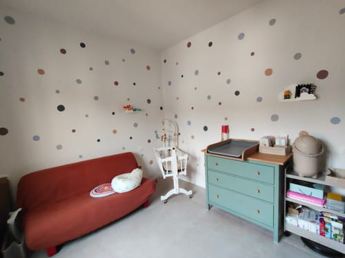 Customer's nursery wall decorated with Polka Dots watercolor nursery wall decals in a colorful, playful pattern.