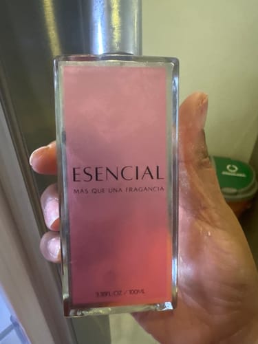 Customer's M135 perfume bottle held in hand, showing a rectangular glass design with a pink label.