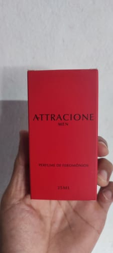 Customer's Attracione Men perfume red box held in a person's hand.