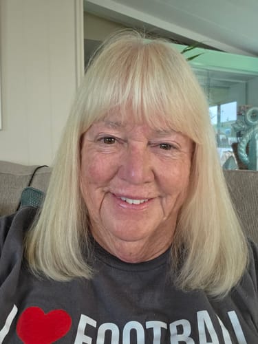 Customer with blonde hair smiling at home, customer photo