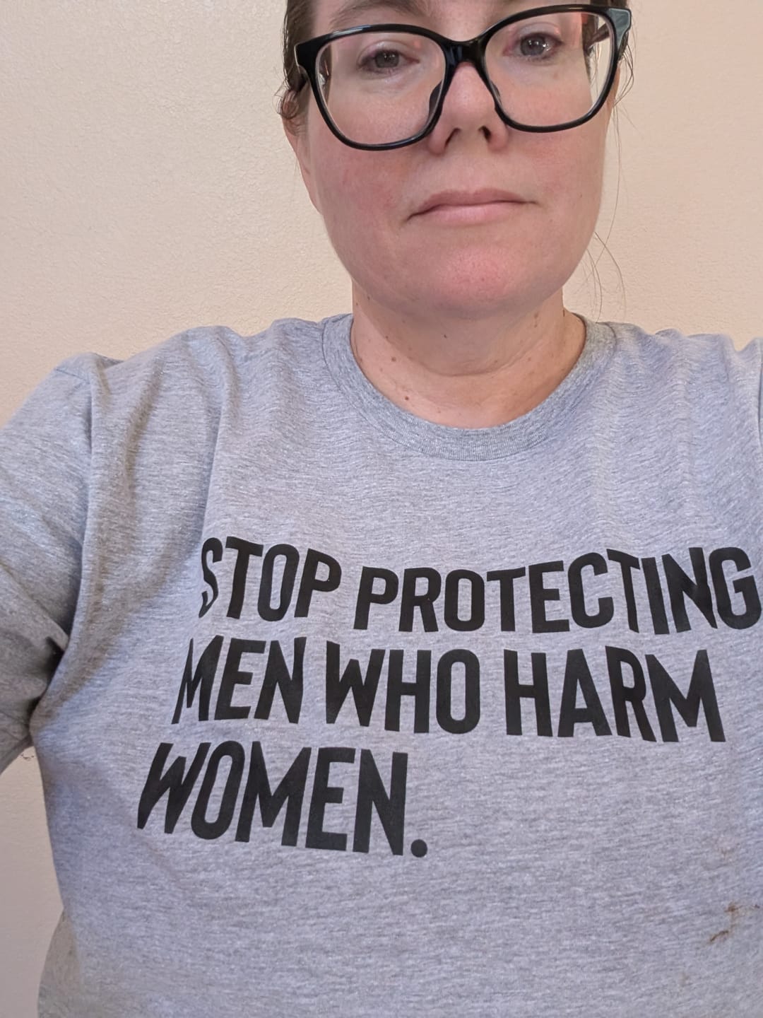 Customer photo review of Stop Protecting Men Who Harm Women Unisex Tee