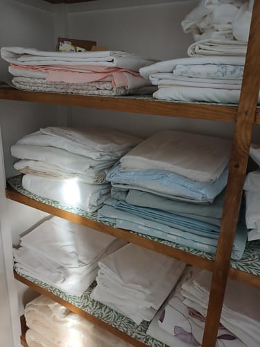Customer's WILLOW William Morris scented drawer liners neatly installed on the wooden shelves of a cupboard.