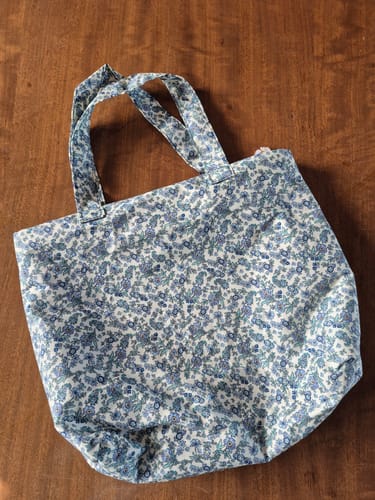 Customer's tote bag made from Daisy Lane Rose & Hubble cotton poplin fabric with a blue floral pattern