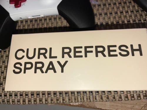 Customer's Curl Refresh Spray packaging, a white rectangular box with clear text.
