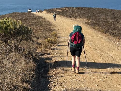 Customer's Vezzana Nuovo leggings worn during a sunny hike on a dirt trail.