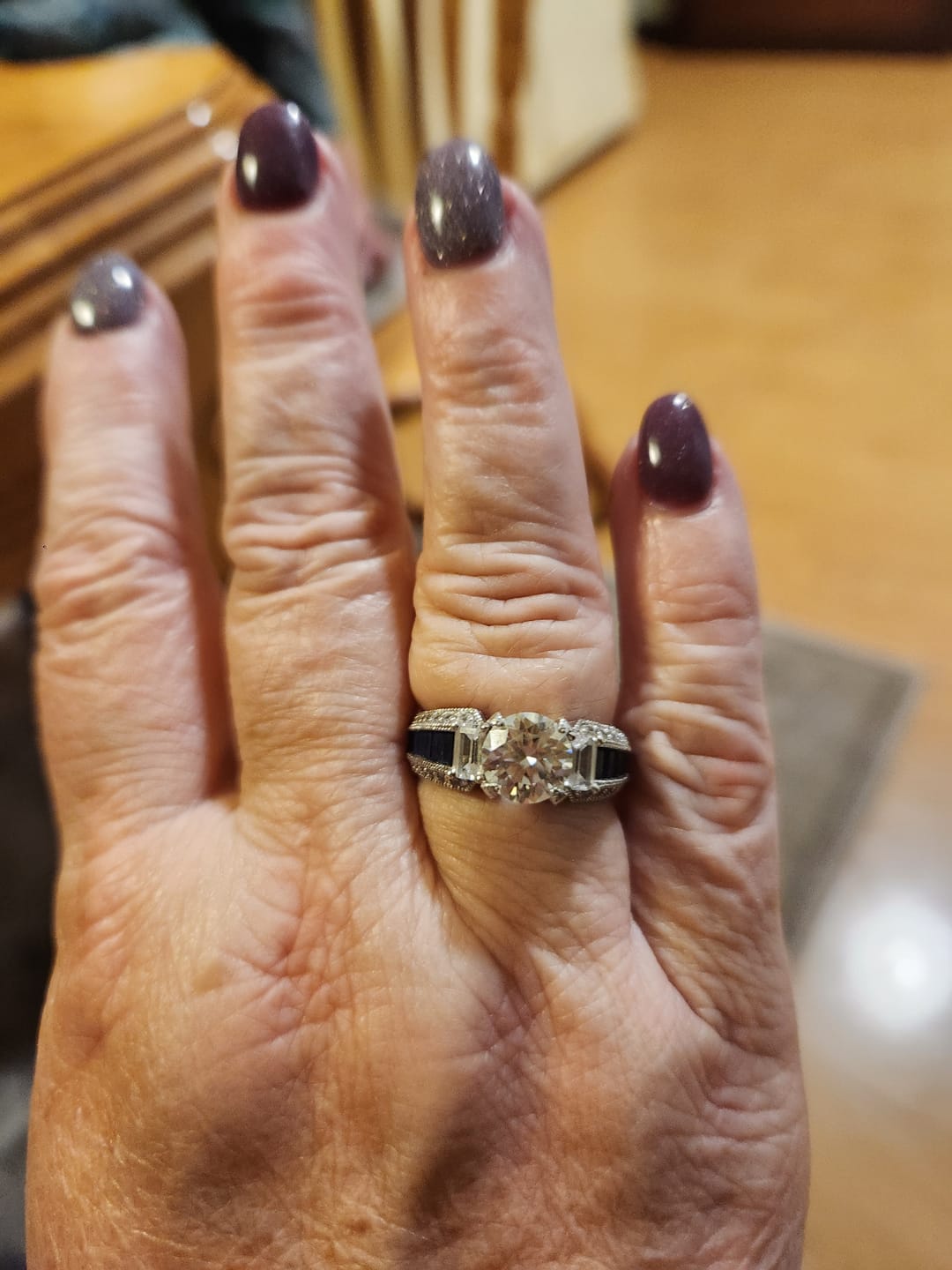 Customer photo review of Round Moissanite And Emerald-Cut Sapphire Channel Set Milgrain Engagement Ring