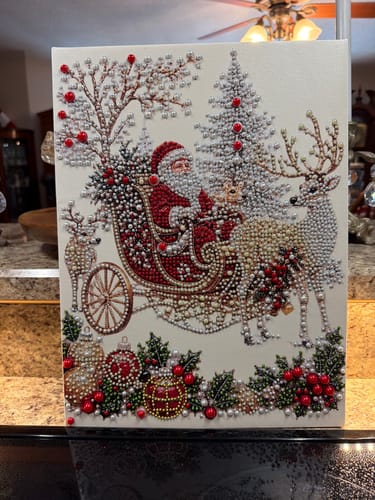 Customer's completed Christmas 3D Pearl Art kit showing Santa in a sleigh with reindeer, trees, and festive decor.