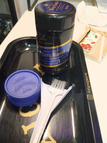 Customer's Divine Banana Deep Roots flower jar with rolling tray, blue grinder, and cleaning brush.