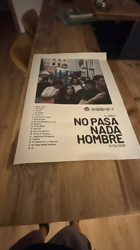 Customer's NO PASA NADA HOMBRE poster with tracklist on a wooden table.