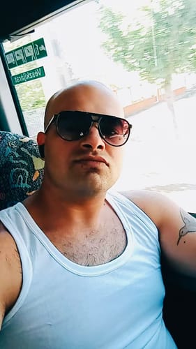 Customer's selfie wearing sunglasses while sitting on public transportation, reviewing THC-A White Truffle Flower.