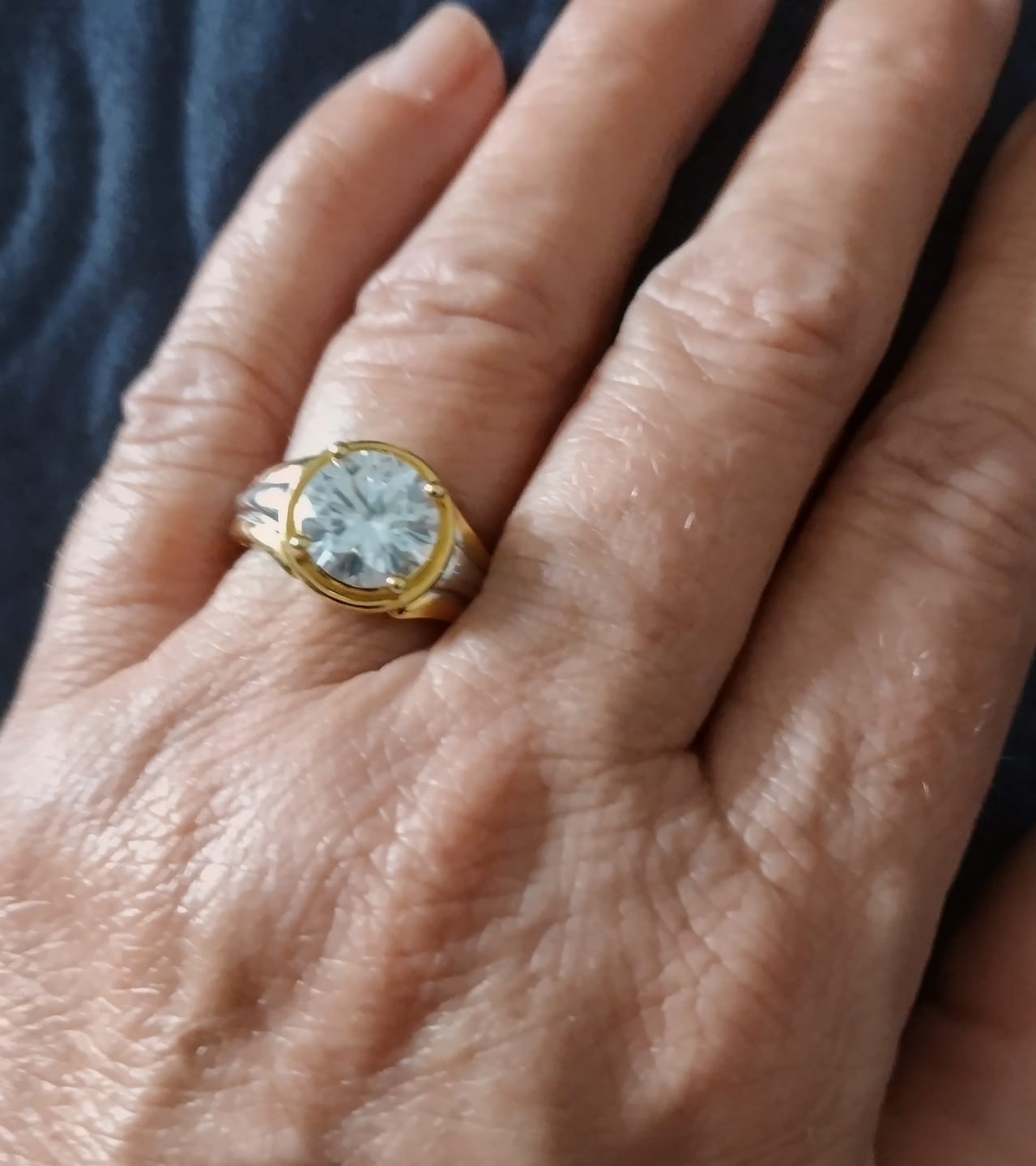 Customer photo review of Solitaire Round Moissanite Streamlined Two-Tone Engagement Ring