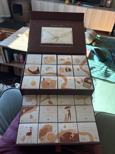 Customer's Advent Calendar with twenty-four small, numbered boxes in a brown, open packaging.
