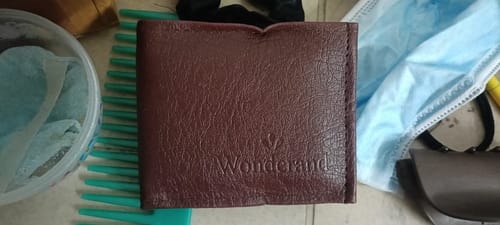 Customer's brown wallet showing the Wonderland brand logo embossed on the front surface