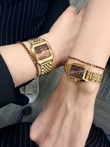 Customer's Macy Gold Burgundy watches on wrists with matching gold bracelets
