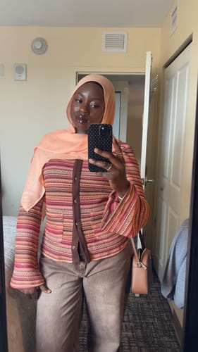 Customer's Peach Premium Modal hijab worn in a mirror selfie, showing the soft orange color.