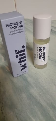 Customer's Midnight Mocha spray bottle and tall rectangular packaging box sitting on a green surface.