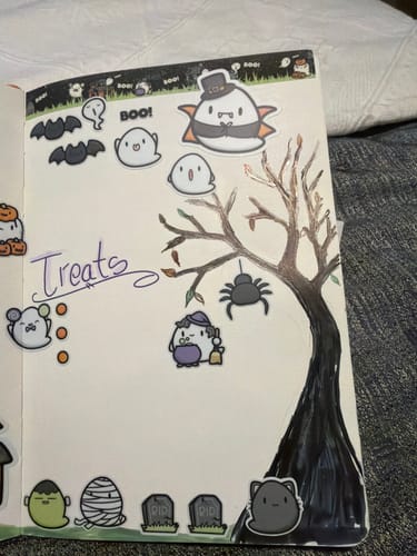 Customer's Spooky Boos Bundle stickers featuring ghosts and bats in a journal spread with a drawn tree