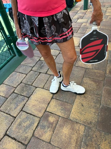 Customer's white CUURT Muuv court shoes being worn on a pickleball court.