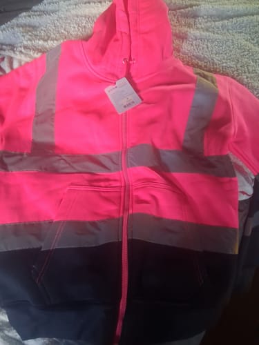 Customer's pink hi vis hooded zipper with reflective silver stripes and dark lower section, laid flat.