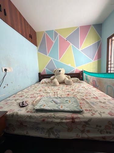 Customer's Flo Anti-Gravity Natural Latex Mattress placed on a bed frame in a bedroom with a teddy bear.