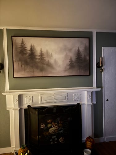 Reviewer's Tailored Boost canvas print showing a foggy forest scene hanging above a white fireplace mantel.