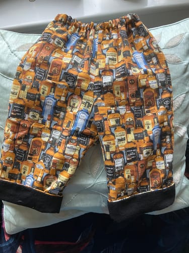 Customer's Plain Brushed Cotton Fabric used as a black hem lining inside patterned trousers.