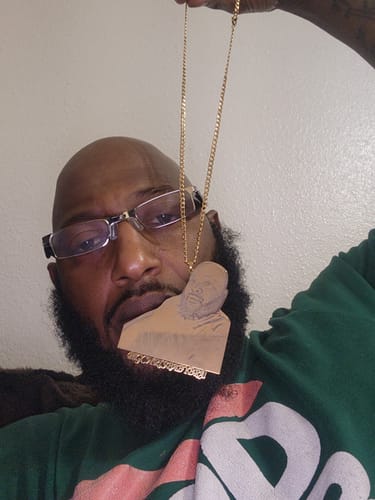 Customer's gold Custom Photo Engraved Pendant Necklace featuring a portrait engraving worn around their neck.
